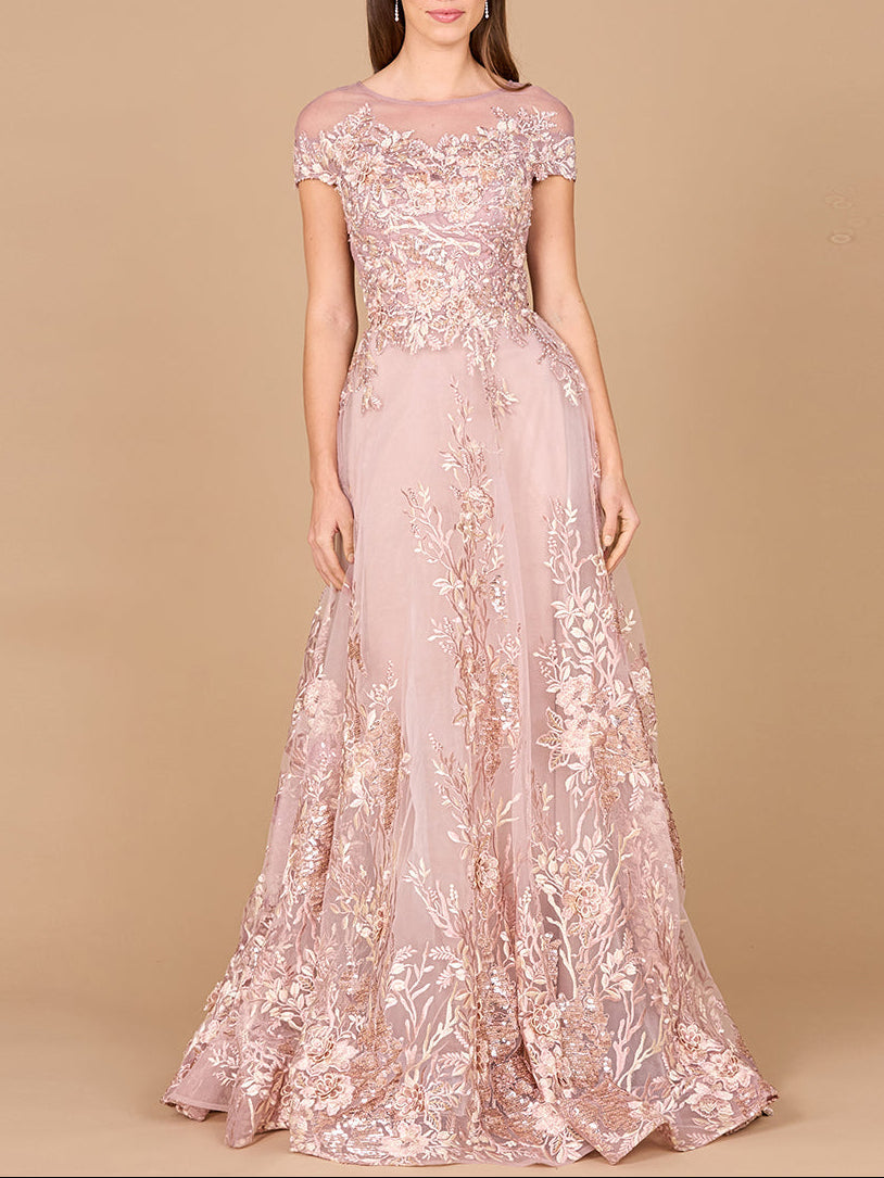 Lara New York lace applique A-line ball gown in dusty rose with intricate lace details and a flowing silhouette.