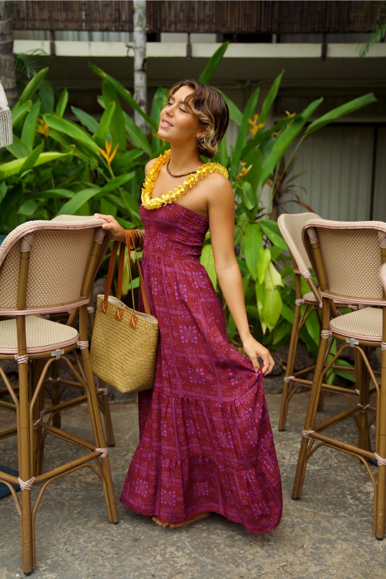 EHA Culture Mango Sunset Maile Dress displayed on a hanger, featuring vibrant tropical print and flowing fabric.