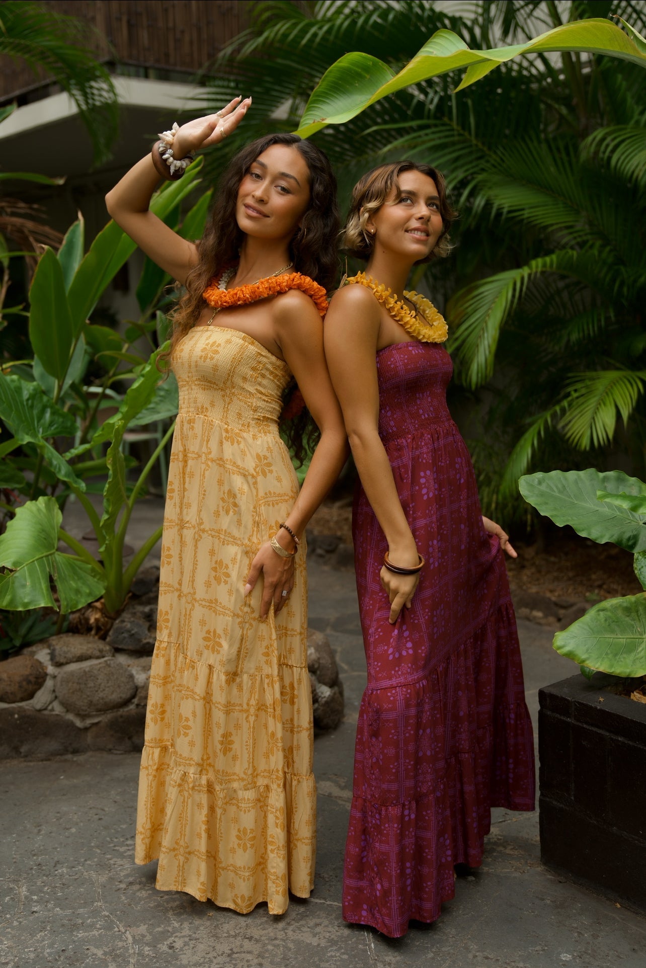 EHA Culture Mango Sunset Maile Dress displayed on a mannequin, featuring vibrant colors and flowing fabric for a tropical look.