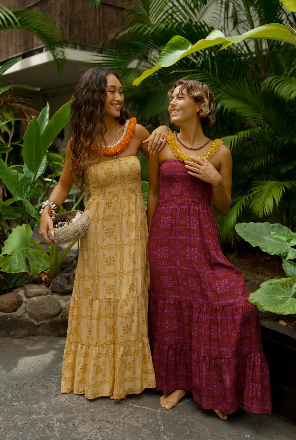 EHA Culture Mango Sunset Maile Dress displayed full-length, featuring vibrant tropical print and flowing fabric.