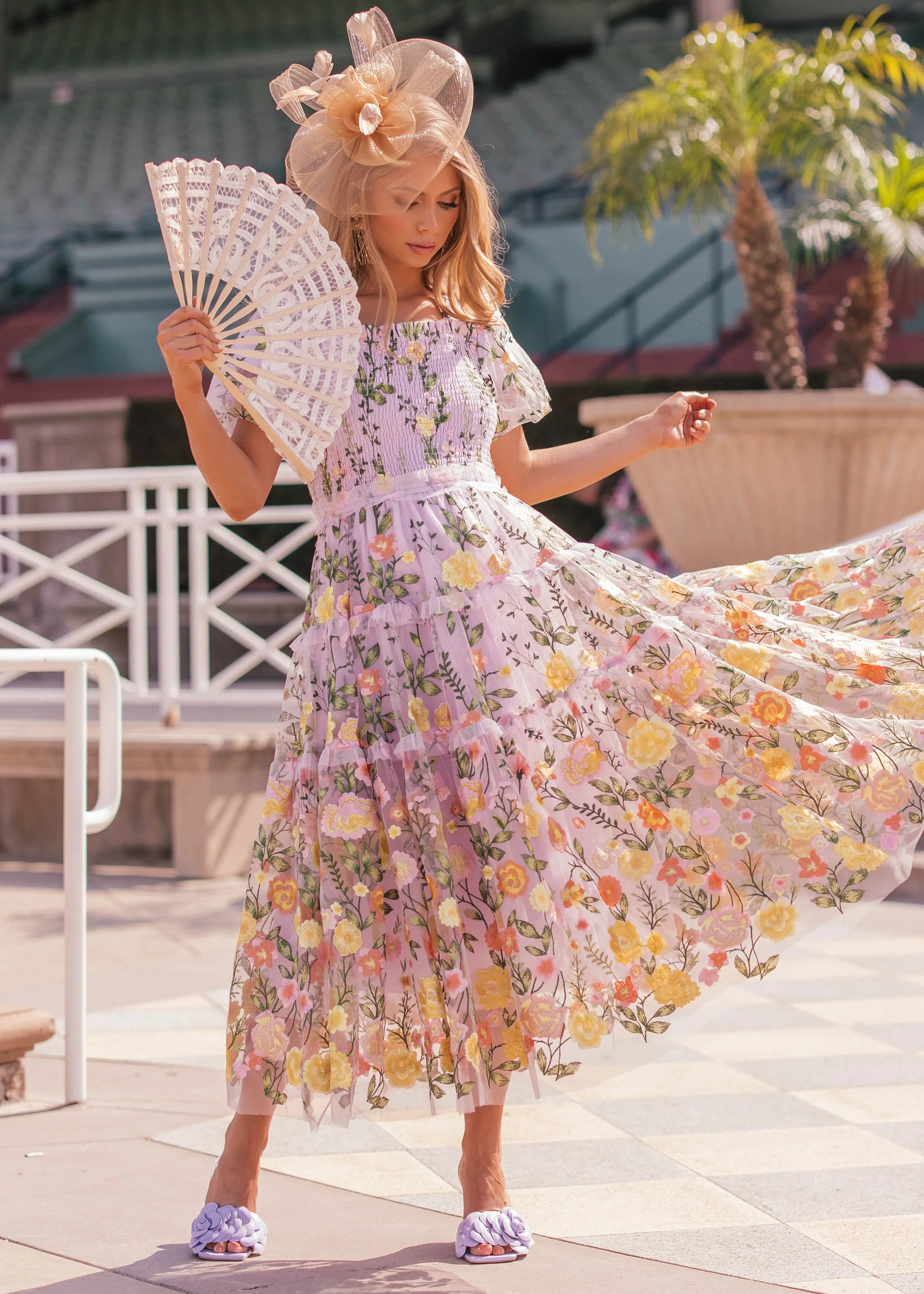 Lavender midi rose dress by JessaKae, featuring a flowy design and delicate fabric, displayed on a hanger.