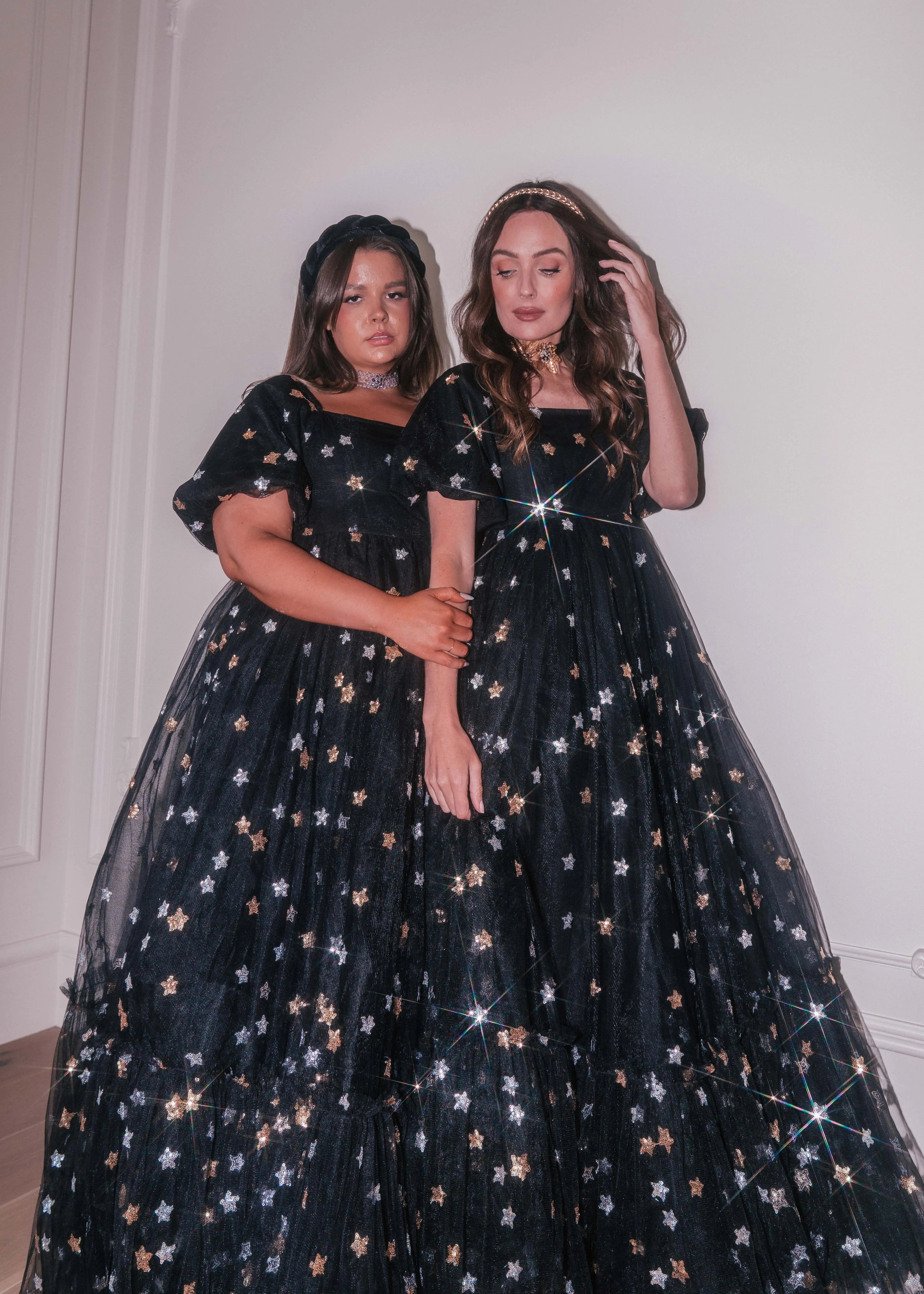 Black Wendy Dress by JessaKae featuring star details, flowing fabric, and a stylish silhouette perfect for casual or semi-formal wear.