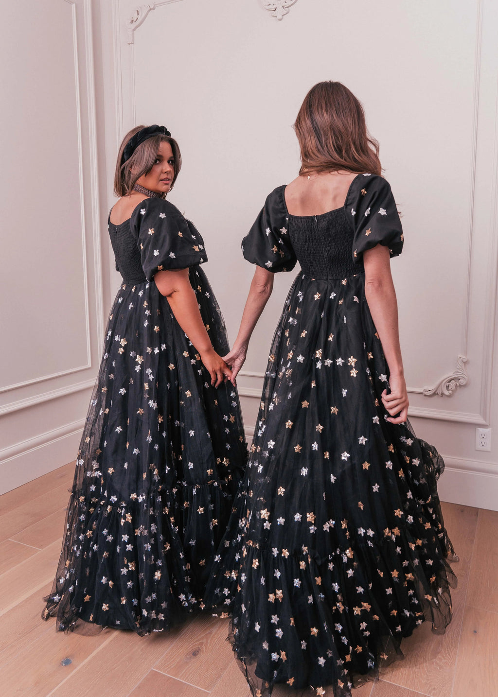 Black Wendy Dress by JessaKae featuring star patterns, sleeveless design, and a fitted silhouette.