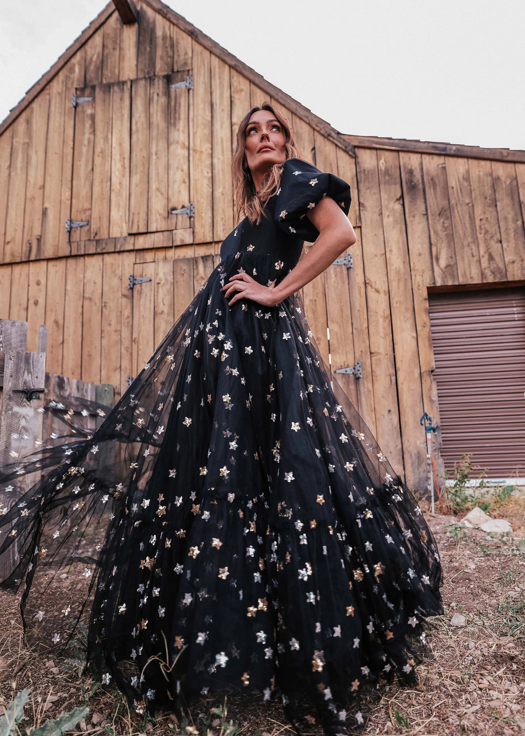 Black Wendy Dress by JessaKae featuring star patterns, short sleeves, and a flowing silhouette, perfect for casual or semi-formal wear.