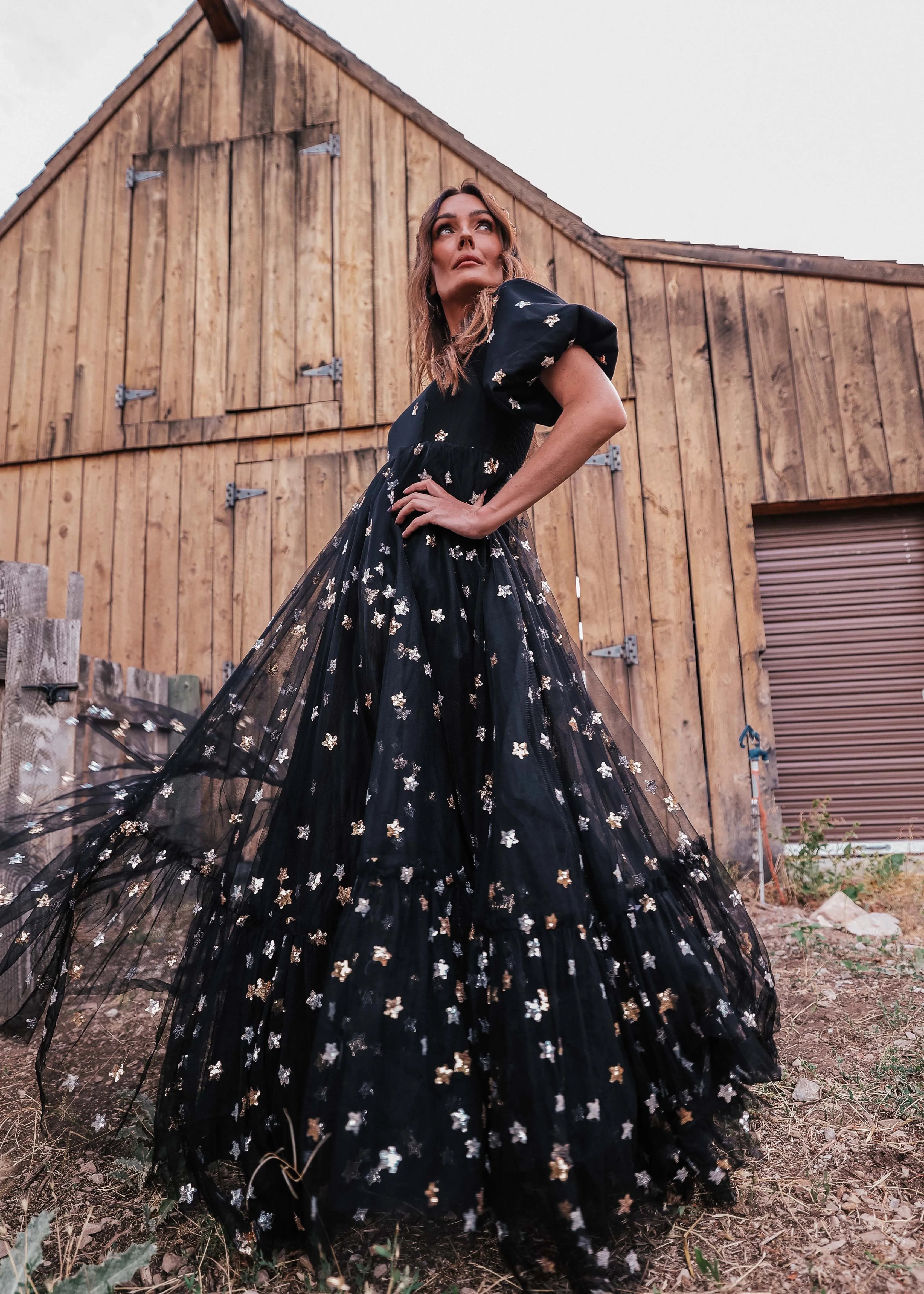 Black Wendy Dress by JessaKae featuring star patterns, short sleeves, and a flowing silhouette, perfect for casual or semi-formal wear.