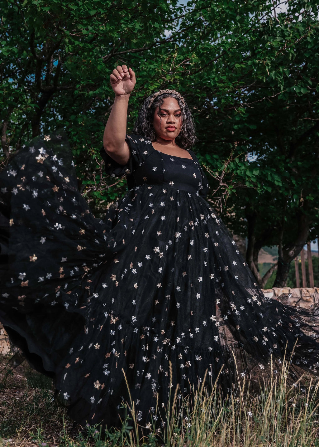 Black Wendy Dress by JessaKae featuring star patterns, sleeveless design, and a flowing silhouette perfect for casual or semi-formal occasions.