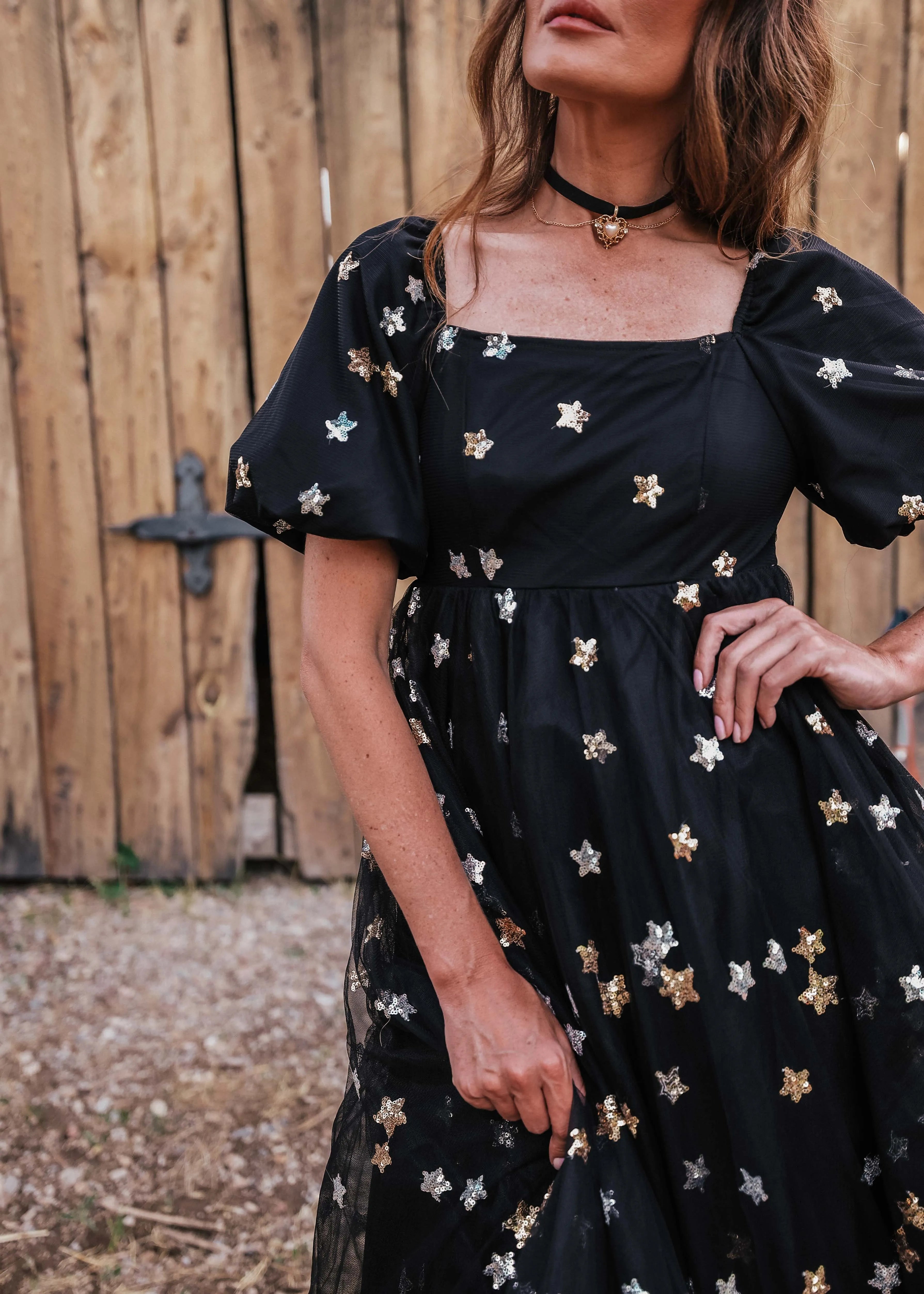 Black Wendy Dress by JessaKae featuring a star pattern, fitted bodice, and flowing skirt, perfect for casual or semi-formal occasions.