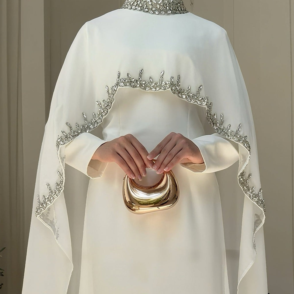 Celestial rhinestone cape abaya by Mariam's Collection, featuring a luxurious embellished shawl and elegant evening dress.