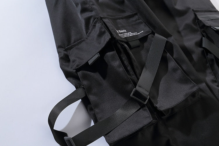 Niepce YE2032 matte black joggers, sweatpants with a relaxed fit and elastic waistband, shown on a hanger.